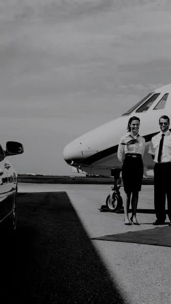 Crew members beside a private aircraft